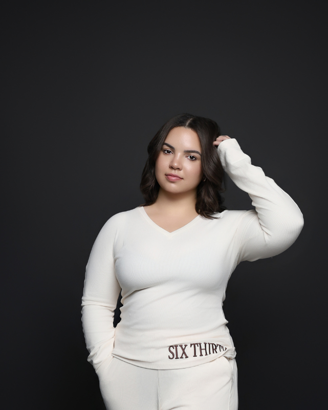 Person wearing a white outfit with 'Six Thirty' branding on a black background