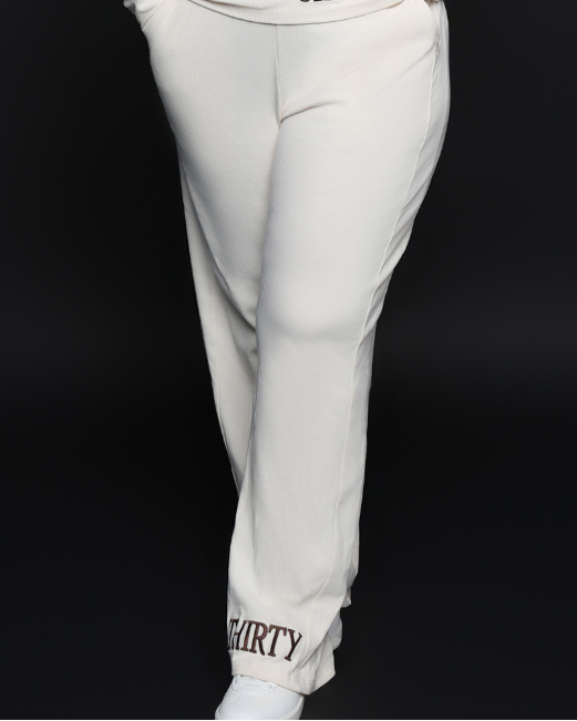 Person wearing a white outfit with 'Six Thirty branding on a black background